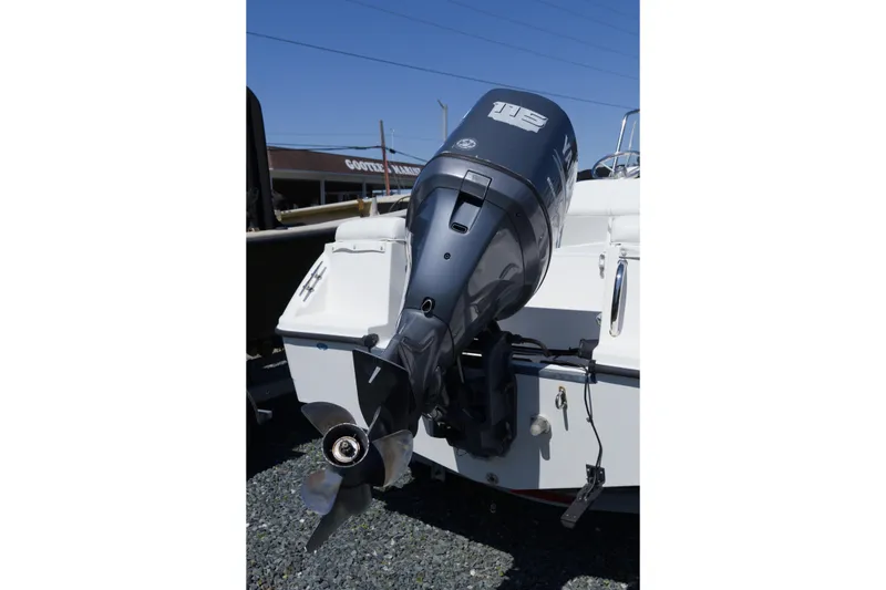 Slide: The Image of 2006 Edgewater 170CC boat with outboard motor, displayed outdoors. - 7