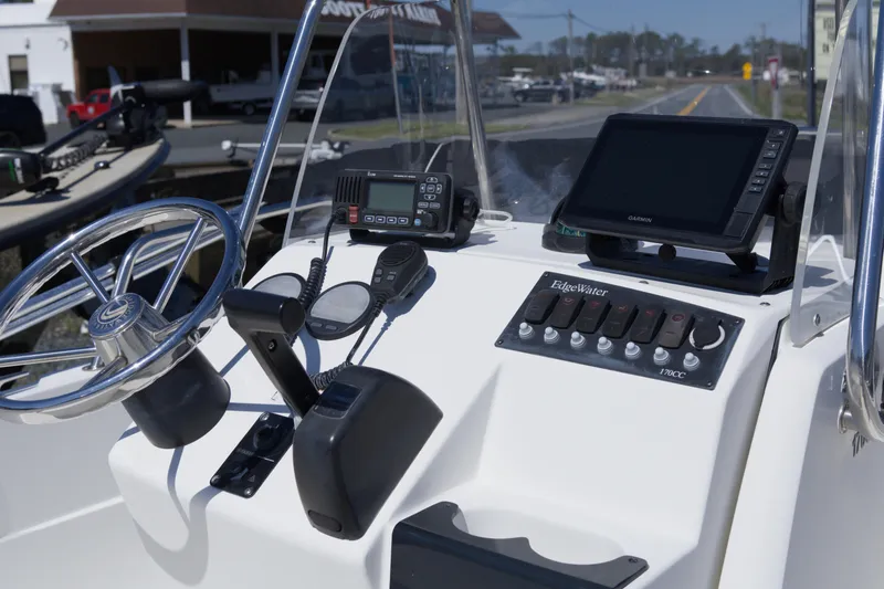 Slide: The Image of 2006 Edgewater 170CC boat console with steering wheel, controls, and navigation equipment. - 8