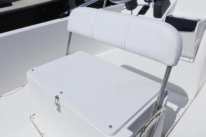 Slide: The Image of White seating area on a 2006 Edgewater 170CC boat, featuring a storage compartment. - 9