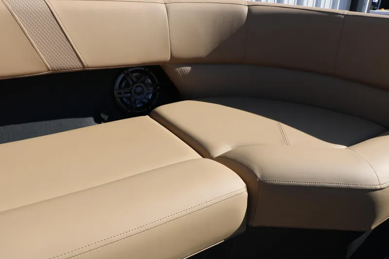 Slide: The Image of Luxurious beige seating on 2026 Evotti 525 QL Tri-Toon boat, featuring integrated speaker. - 37