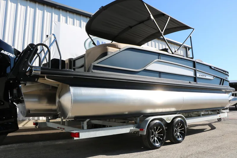 Slide: The Image of 2026 Evotti 525 QL Tri-Toon boat on trailer, featuring sleek design and modern amenities. - 10