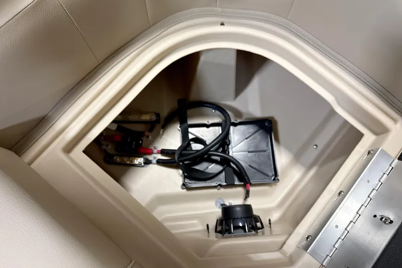 Slide: The Image of Battery compartment of 2026 Godfrey EX 2286 SBX boat, featuring wiring and secure housing. - 12