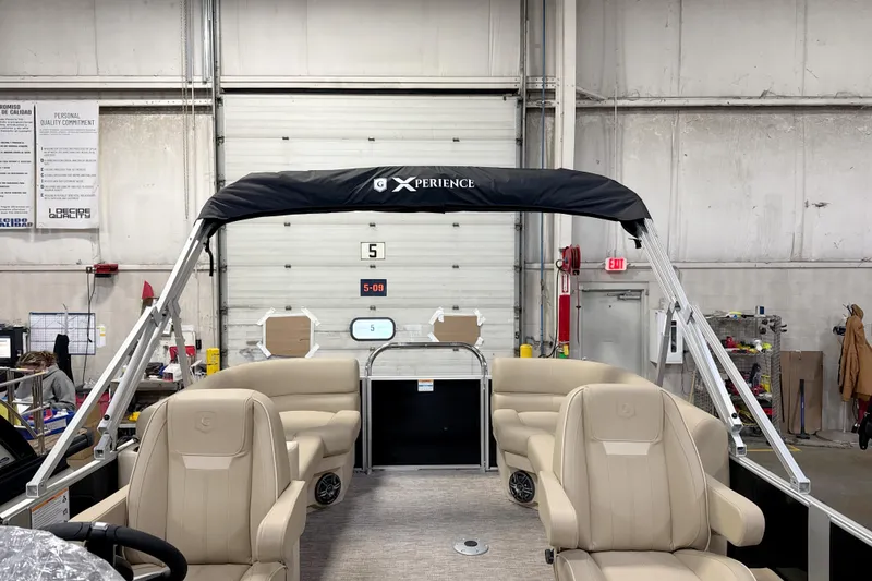 Slide: The Image of 2026 Godfrey EX 2286 SBX pontoon boat interior in a warehouse setting. - 13