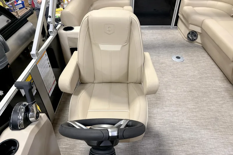 Slide: The Image of Captain's chair and helm of 2026 Godfrey EX 2286 SBX pontoon boat interior. - 8