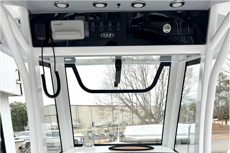 Slide: The Image of 2025 Sea Hunt Ultra 275 SE boat console with Garmin electronics and overhead storage. - 10