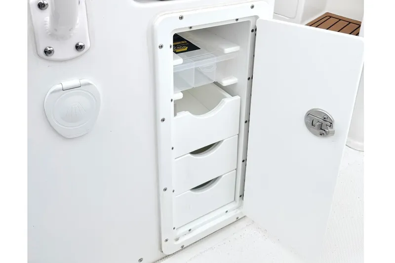 Slide: The Image of Storage compartment with drawers on a 2025 Sea Hunt Ultra 275 SE boat. - 14
