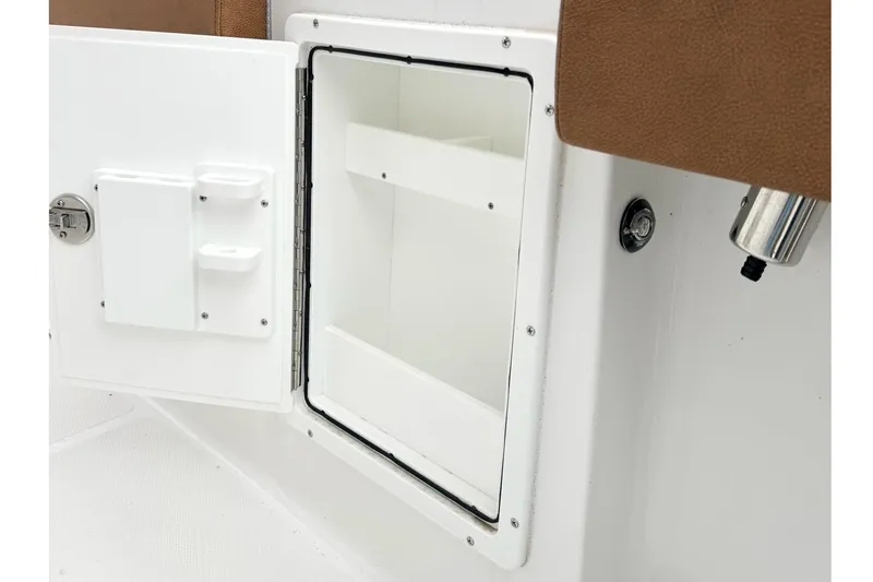 Slide: The Image of Open storage compartment on 2025 Sea Hunt Ultra 275 SE boat interior. - 15