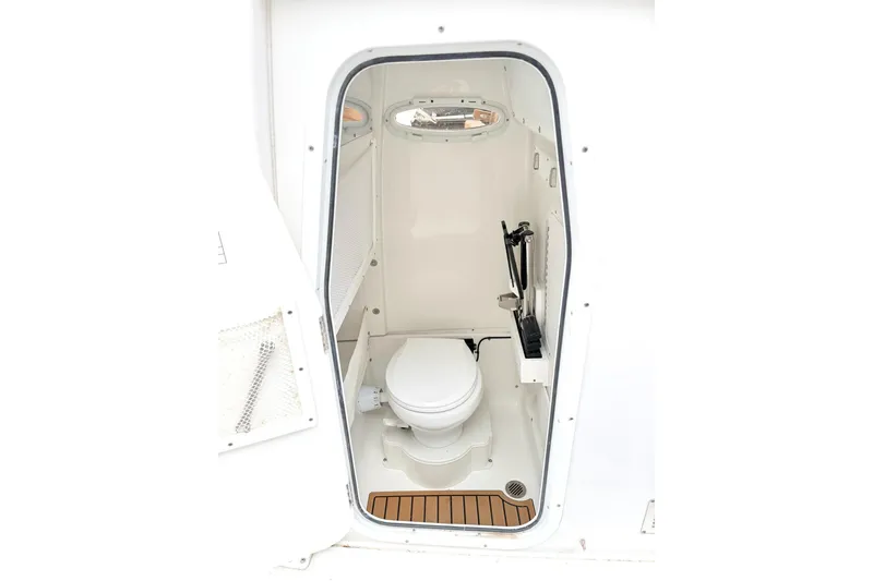 Slide: The Image of 2025 Sea Hunt Ultra 275 SE boat interior with compact marine toilet. - 16