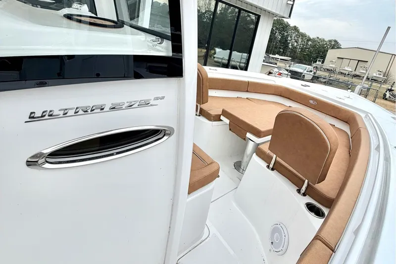 Slide: The Image of 2025 Sea Hunt Ultra 275 SE boat interior with tan seating and sleek design. - 18