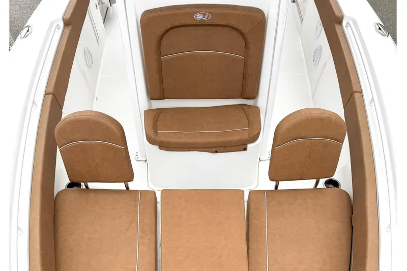 Slide: The Image of 2025 Sea Hunt Ultra 275 SE boat interior with tan cushioned seating and white deck. - 21