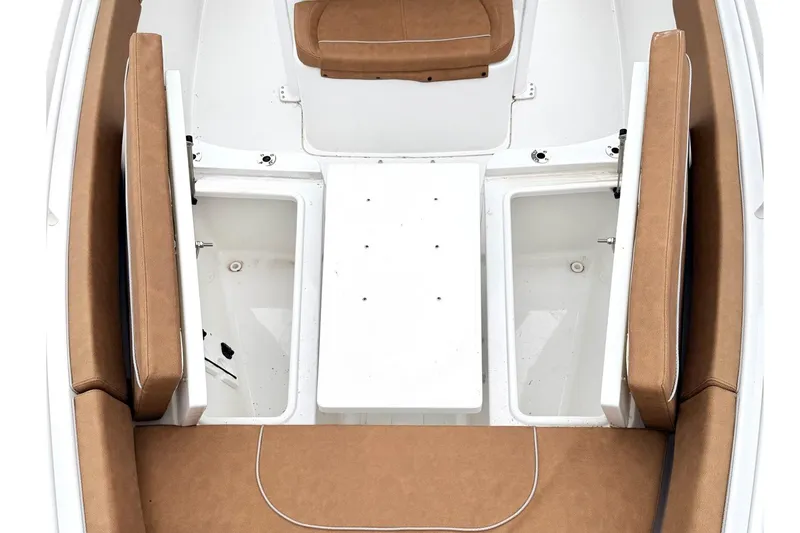 Slide: The Image of 2025 Sea Hunt Ultra 275 SE boat interior with tan seating and storage compartments. - 23