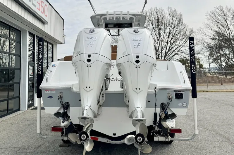 Slide: The Image of 2025 Sea Hunt Ultra 275 SE boat with twin 250 V6 engines at Marine 360 dealership. - 3