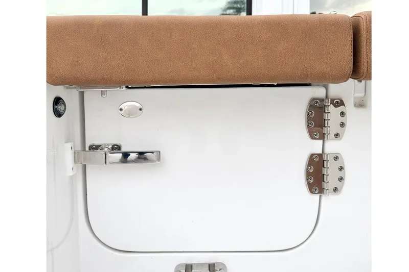 Slide: The Image of 2025 Sea Hunt Ultra 275 SE boat door with brown cushion and stainless steel hinges. - 5