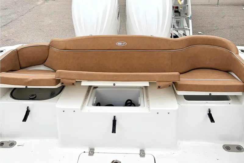 Slide: The Image of 2025 Sea Hunt Ultra 275 SE boat with tan seating and storage compartments. - 7