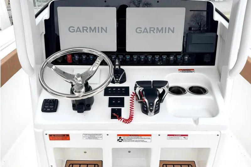 Slide: The Image of 2025 Sea Hunt Ultra 275 SE helm with Garmin displays and modern controls. - 9