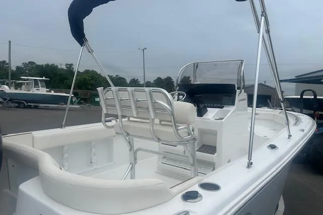 Slide: The Image of 2022 Sea Hunt Ultra 219 boat with white interior and seating, docked outdoors. - 5