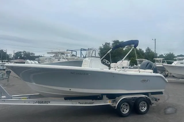 Slide: The Image of 2022 Sea Hunt Ultra 219 boat on trailer, parked outdoors. - 8