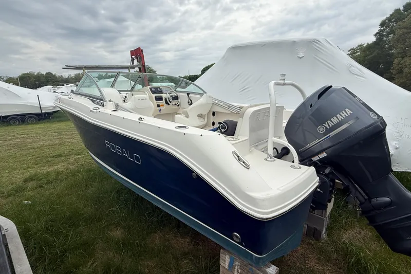 Slide: The Image of 2013 Robalo R207 Dual Console boat with Yamaha engine on grassy field. - 2