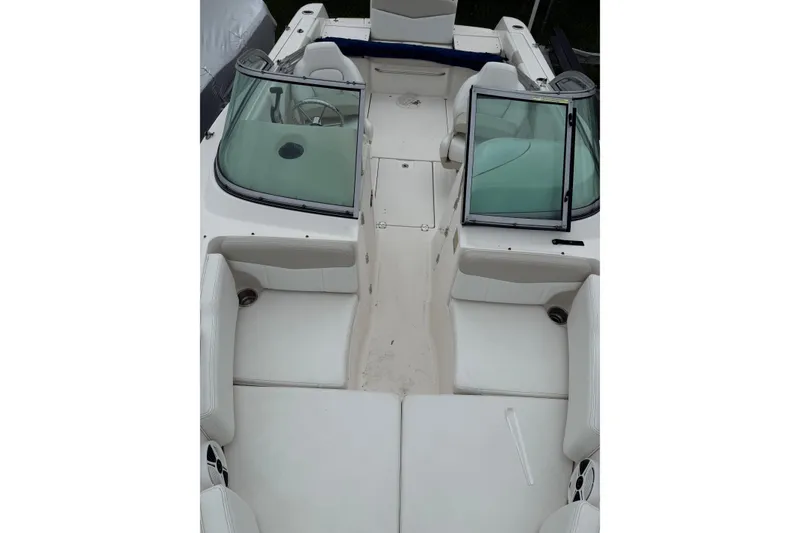 Slide: The Image of 2013 Robalo R207 Dual Console boat interior with white seating and windshield. - 4