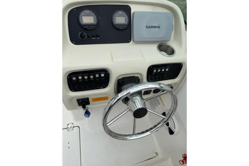 Slide: The Image of 2013 Robalo R207 Dual Console dashboard with Garmin navigation and steering wheel. - 5