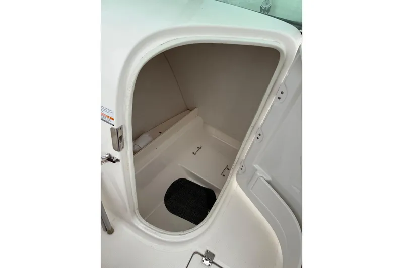 Slide: The Image of 2013 Robalo R207 Dual Console boat storage compartment interior view. - 6