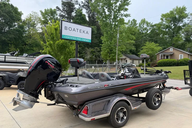 Slide: The Image of 2023 Ranger Z518 boat at Boateka, certified pre-owned, parked outdoors. - 2