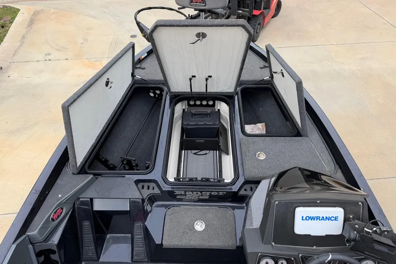 Slide: The Image of 2023 Ranger Z518 boat interior with open storage compartments and Lowrance electronics. - 3