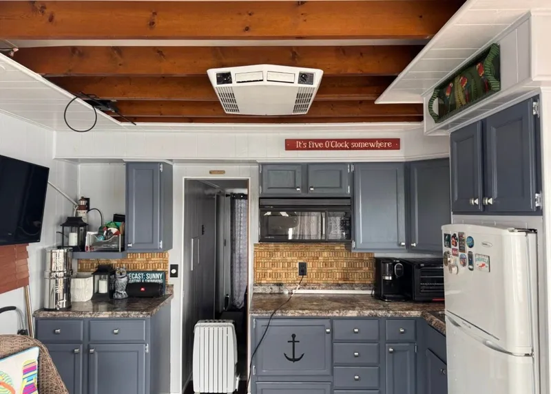 Slide: The Image of Kitchen in 1984 Sommerset Worlds Fair Edition RV with blue cabinets and wooden beams. - 3