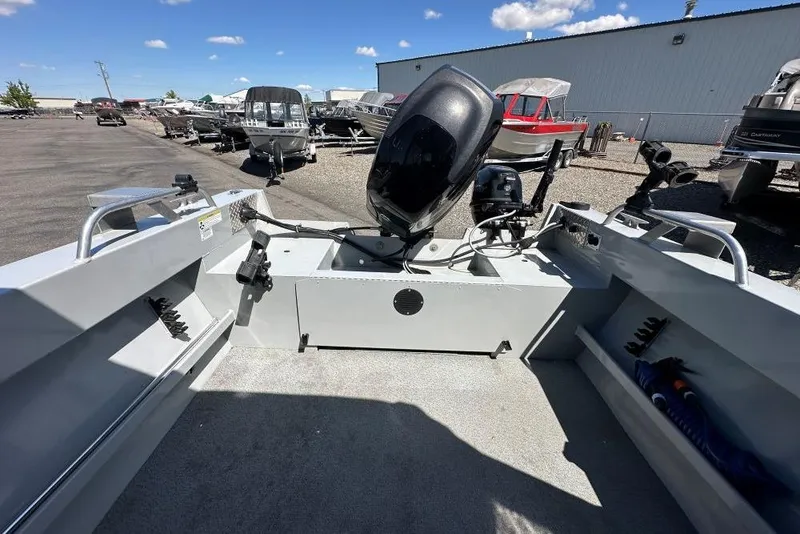 Slide: The Image of 2015 Hewescraft 180 Sportsman boat with motor, parked outdoors under a clear blue sky. - 8