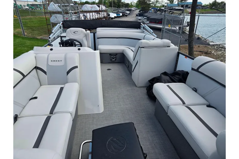 Slide: The Image of 2023 Crest Classic LX 200 pontoon boat interior with plush seating and modern design. - 10