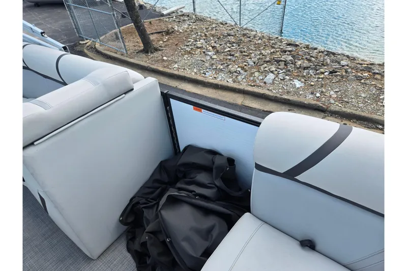 Slide: The Image of 2023 Crest Classic LX 200 boat interior with gray seating and storage area. - 11