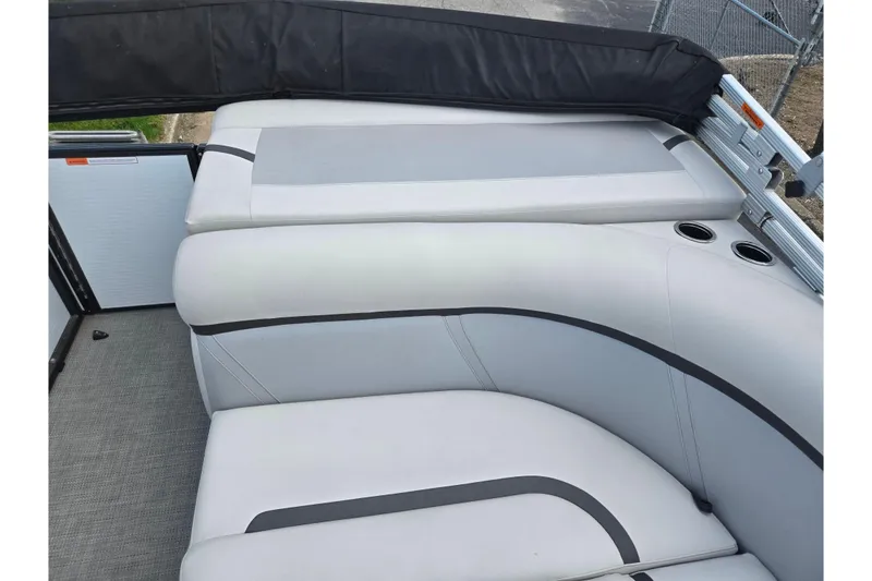 Slide: The Image of 2023 Crest Classic LX 200 boat interior with gray cushioned seating and cup holders. - 13