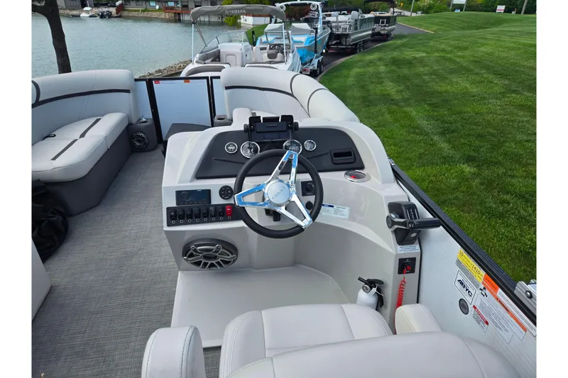 Slide: The Image of 2023 Crest Classic LX 200 boat interior with steering wheel and seating. - 19