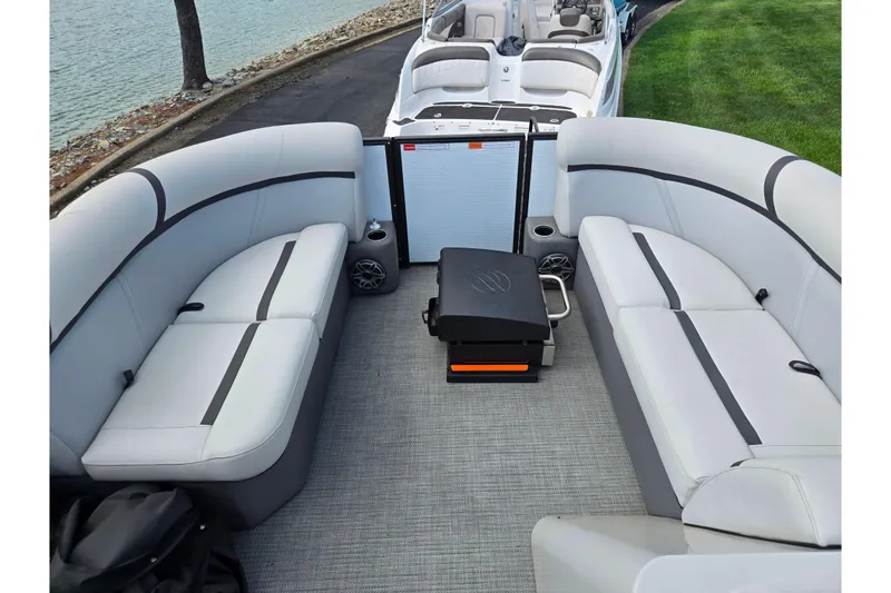 Slide: The Image of 2023 Crest Classic LX 200 pontoon boat interior with plush seating and modern design. - 22