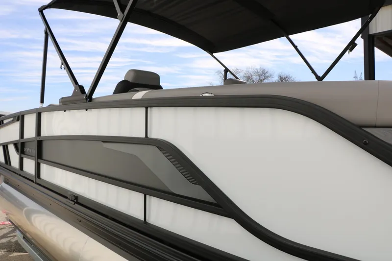 Slide: The Image of 2026 Evotti 723QL pontoon boat with sleek design and canopy against blue sky. - 10