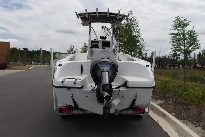 Slide: The Image of 2002 Seaswirl Striper 2101 Center Console boat with outboard motor, parked outdoors. - 11