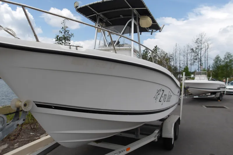 Slide: The Image of 2002 Seaswirl Striper 2101 Center Console boat on trailer, parked outdoors. - 2