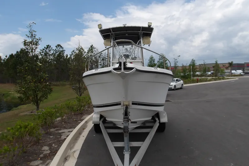Slide: The Image of 2002 Seaswirl Striper 2101 Center Console boat on trailer, parked outdoors. - 3