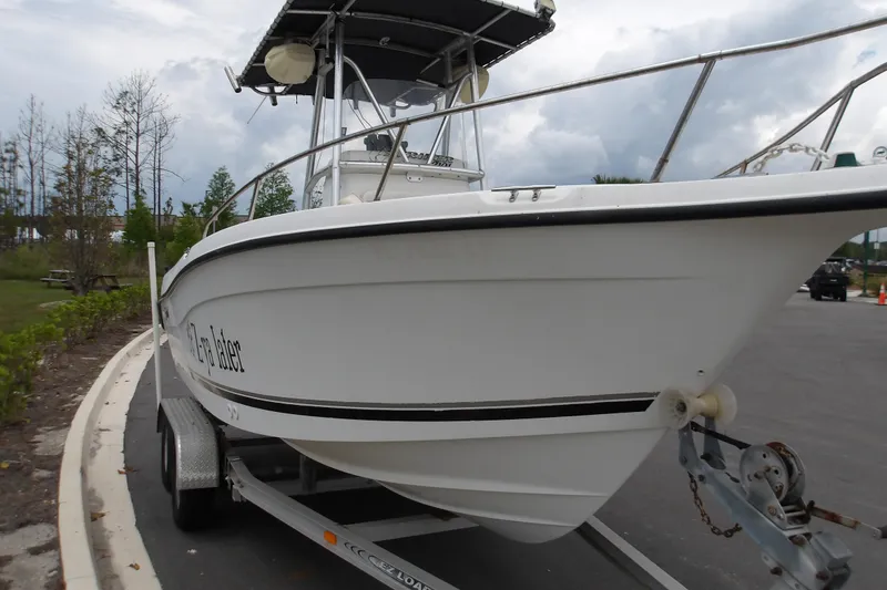 Slide: The Image of 2002 Seaswirl Striper 2101 Center Console boat on trailer, parked outdoors. - 4