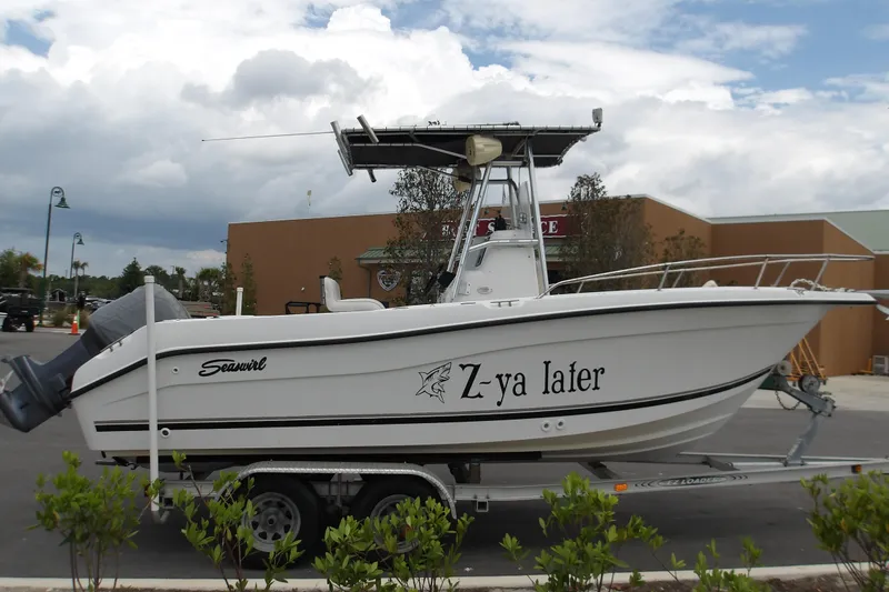 Slide: The Image of 2002 Seaswirl Striper 2101 Center Console boat on trailer, parked outdoors. - 5