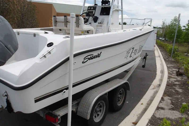 Slide: The Image of 2002 Seaswirl Striper 2101 Center Console O/B boat on trailer, parked outdoors. - 6