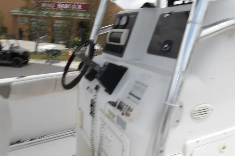 Slide: The Image of 2002 Seaswirl Striper 2101 Center Console boat dashboard with steering wheel and controls. - 8
