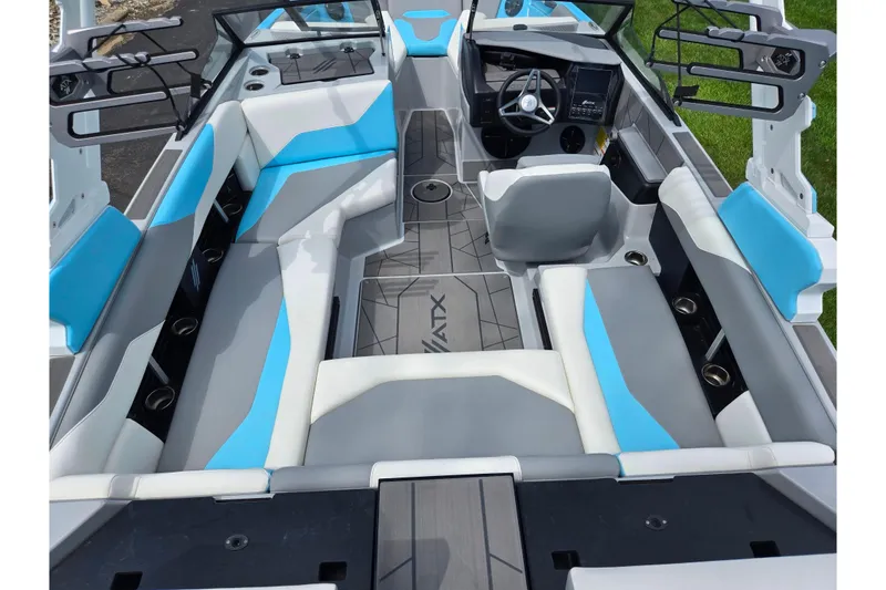 Slide: The Image of 2023 ATX Surf Boats 20 Type-S interior with blue and gray seating, modern dashboard. - 12