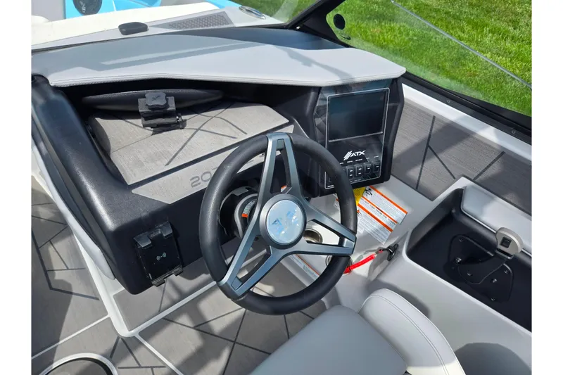 Slide: The Image of 2023 ATX Surf Boats 20 Type-S dashboard with steering wheel and control panel. - 15