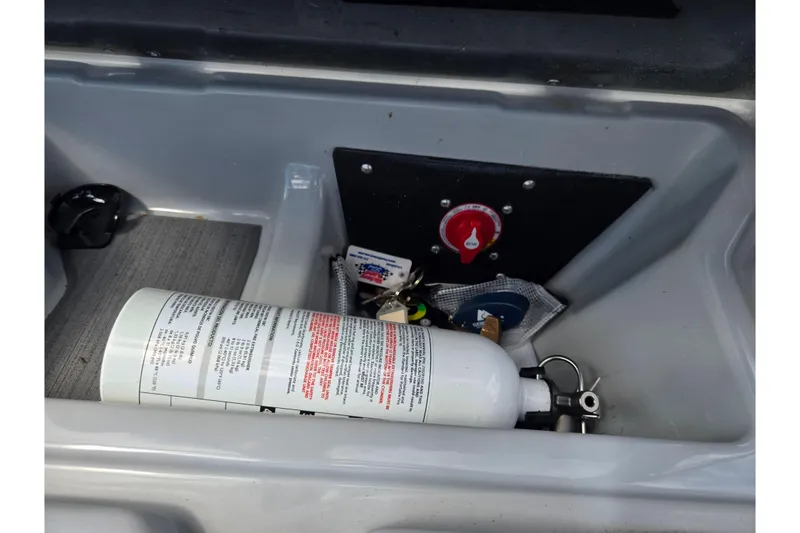 Slide: The Image of Storage compartment in a 2023 ATX Surf Boats 20 Type-S with safety equipment. - 17
