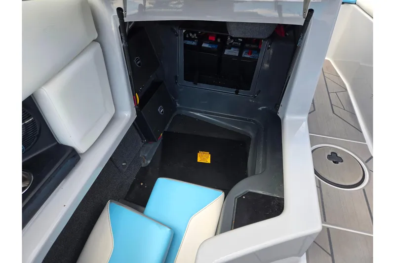 Slide: The Image of 2023 ATX Surf Boats 20 Type-S interior storage compartment with battery access. - 18