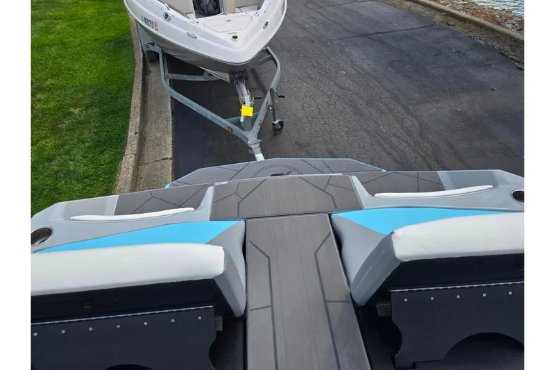 Slide: The Image of 2023 ATX Surf Boats 20 Type-S on trailer, rear view, parked on pavement. - 26