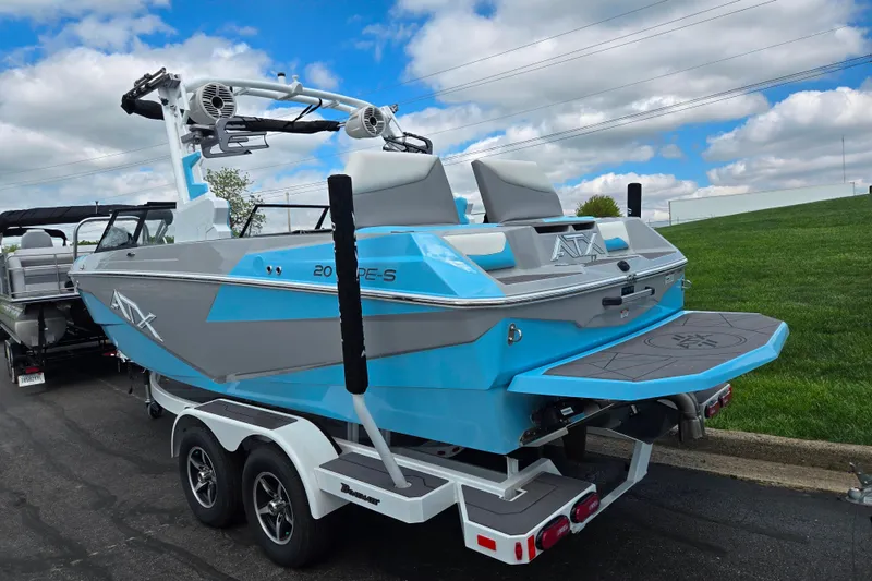 Slide: The Image of 2023 ATX Surf Boats 20 Type-S in blue and gray on trailer, parked outdoors. - 4