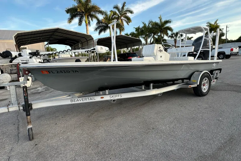 The Image of 2021 Beavertail Skiffs Vengeance boat on trailer, parked outdoors with palm trees in background. - 1