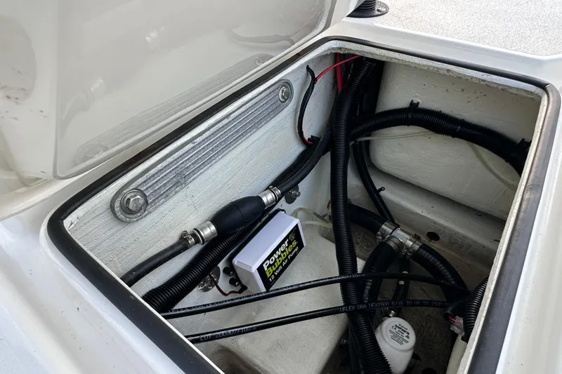 Slide: The Image of 2021 Beavertail Skiffs Vengeance boat compartment with wiring and Power Bubbles air pump. - 10